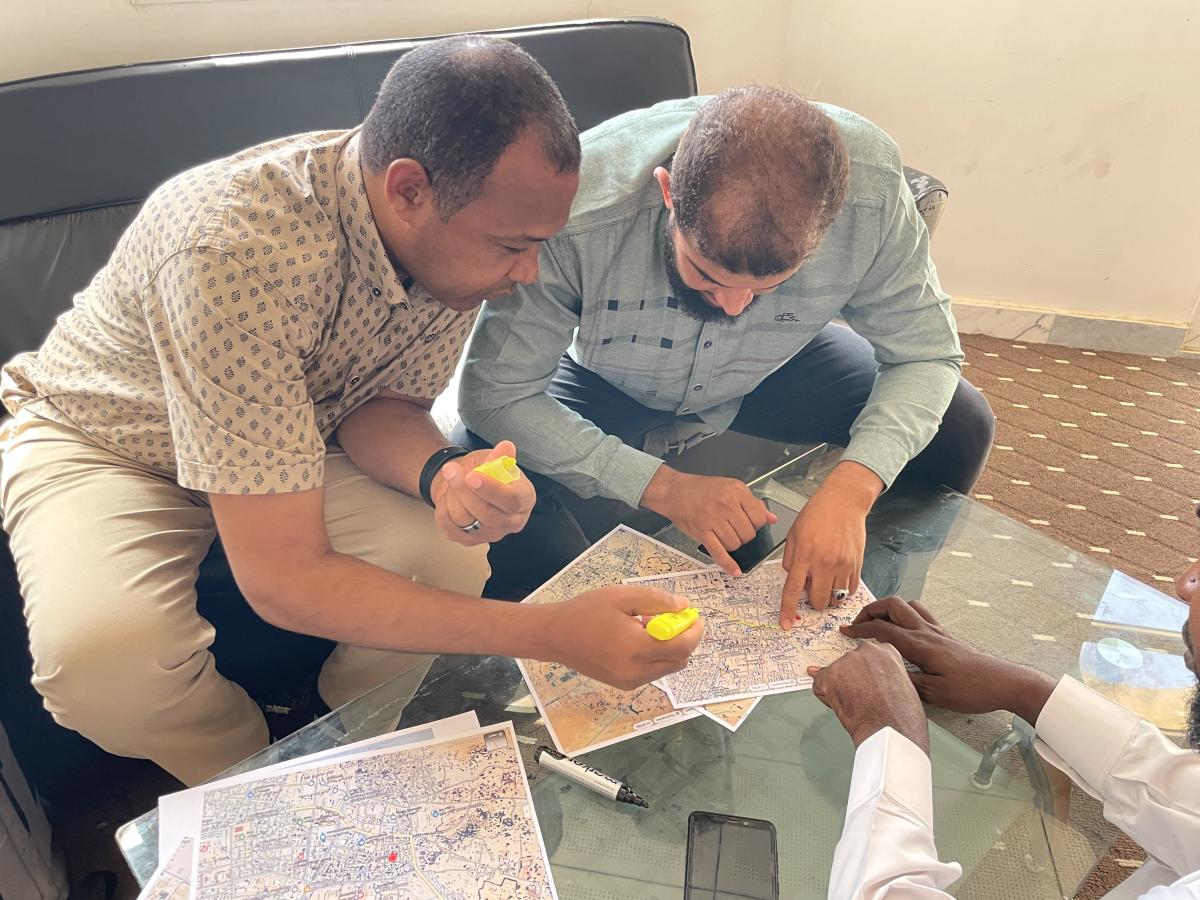 Murzuq Steering Committee members review maps for reconstruction plans.