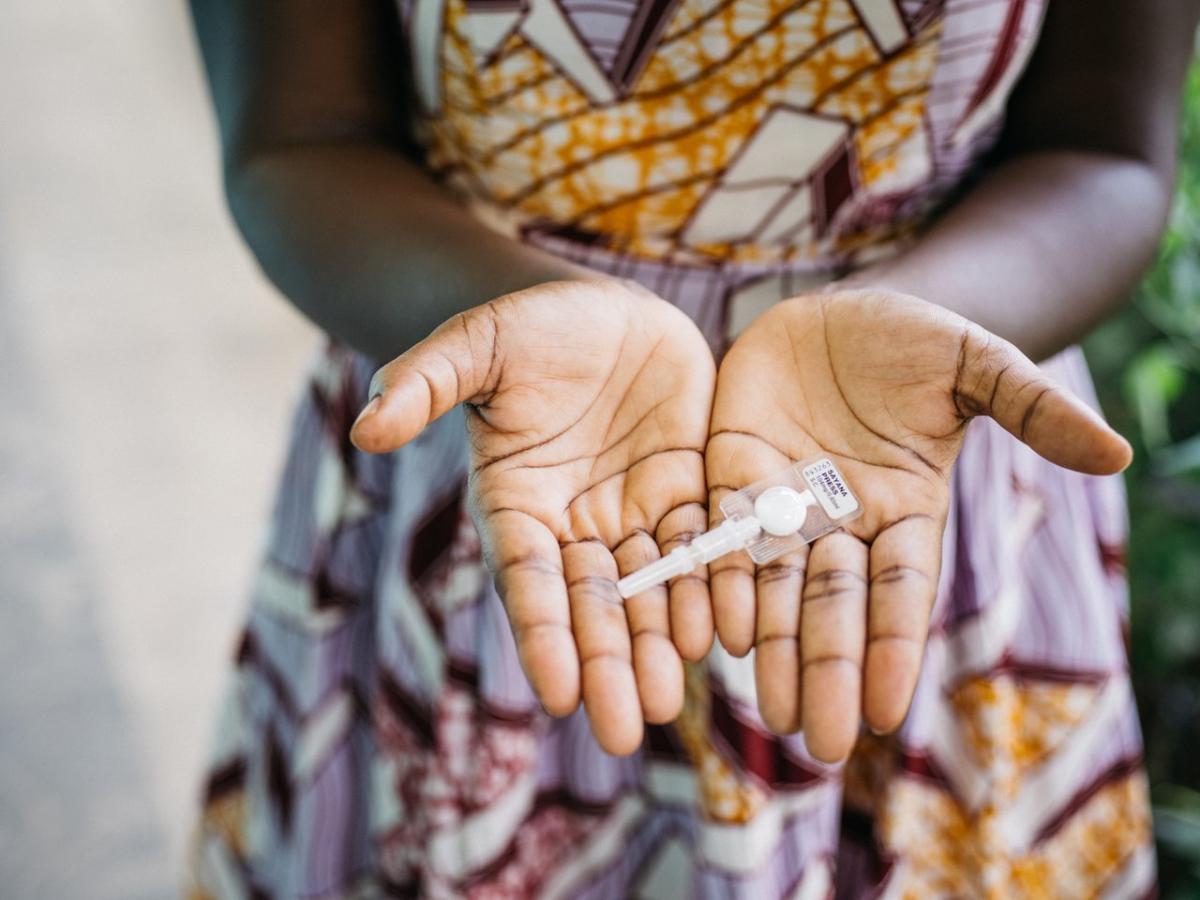 Closeup of open hands holding a contraception device