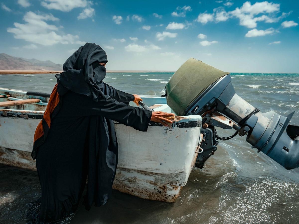 woman diver next to a boat