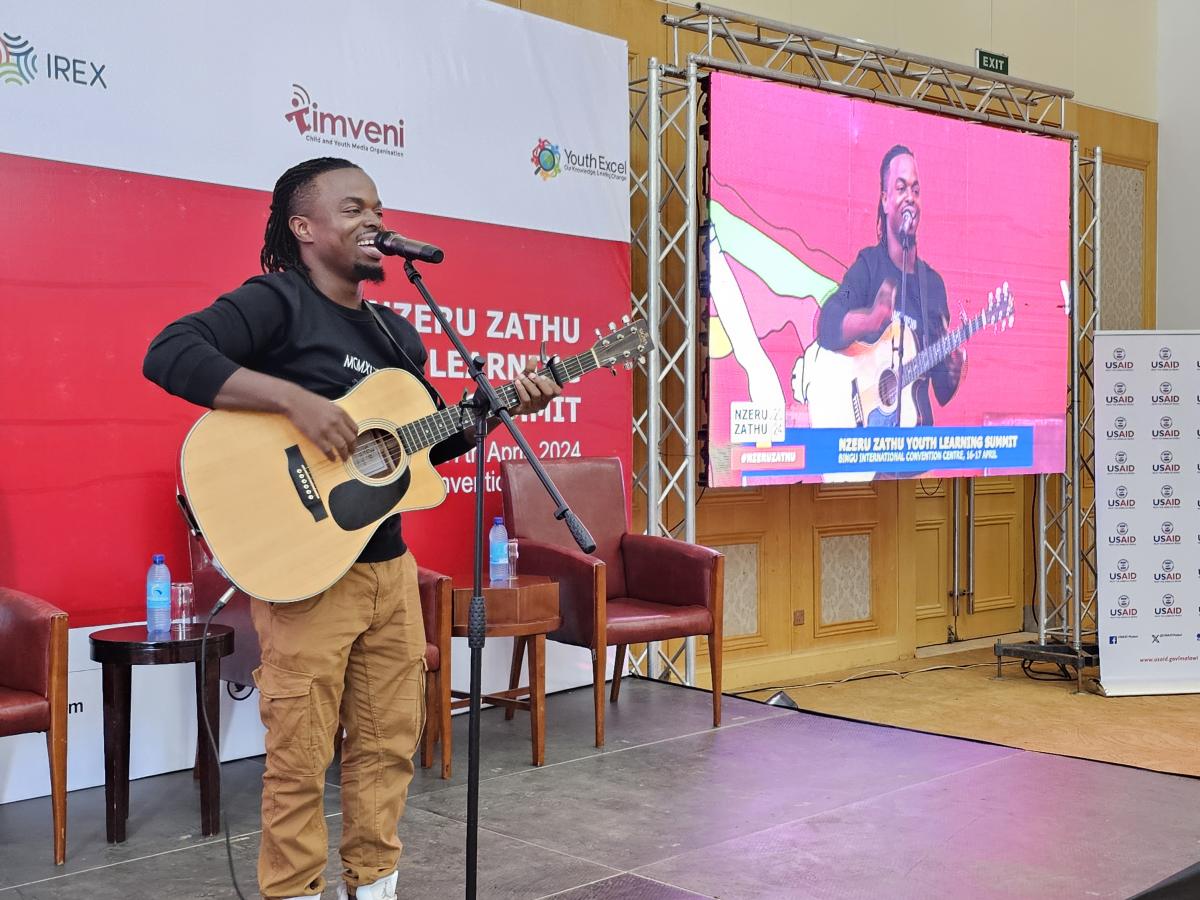 One of Malawi's young, talented and trending musicians, Praise Umali, performs some of his songs to entertain the participants with his tunes and verses. Photo: Oris Chimenya/USAID