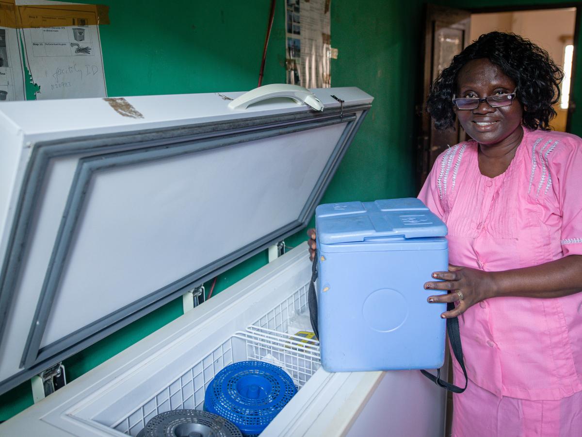 Nurse standing next to a freezer