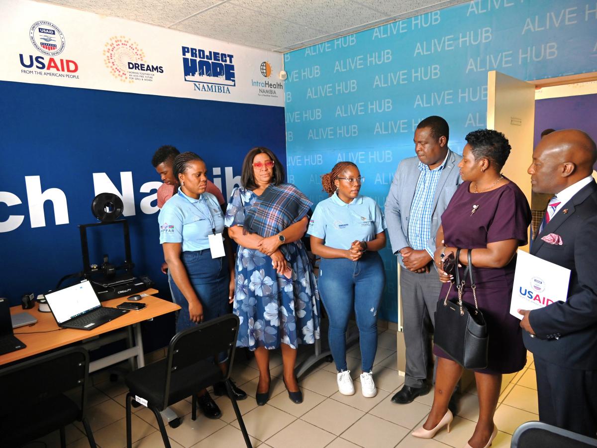 Reach Namibia’s Economic Strengthening Officer Elina Nkambale (center) explains the ALIVE Hub to Deputy Minister for Sport, Youth and National Service, Hon. Dr. Emma Kantema-Gaomas (second from right) and USAID Acting Country Representative Dr. Rockfeler Herisse (right).