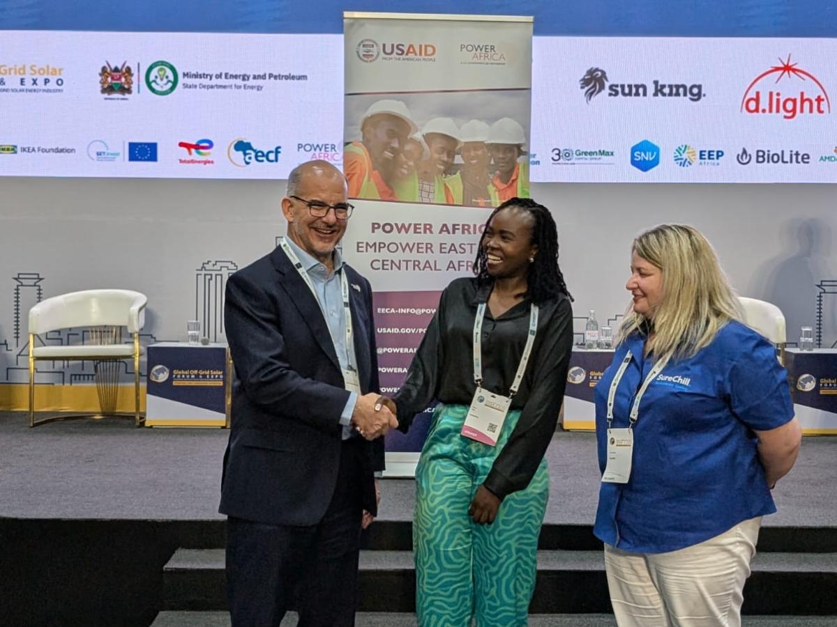 Power Africa Acting Coordinator. Ted Lawrence. with SureChill's Senior Partnership Manager, Diana Sasi, and Chief Commercial Officer, Ceri Jones, at the eighth Global Off-Grid Solar Forum and Expo in Nairobi, Kenya, where the grant winners were announced.