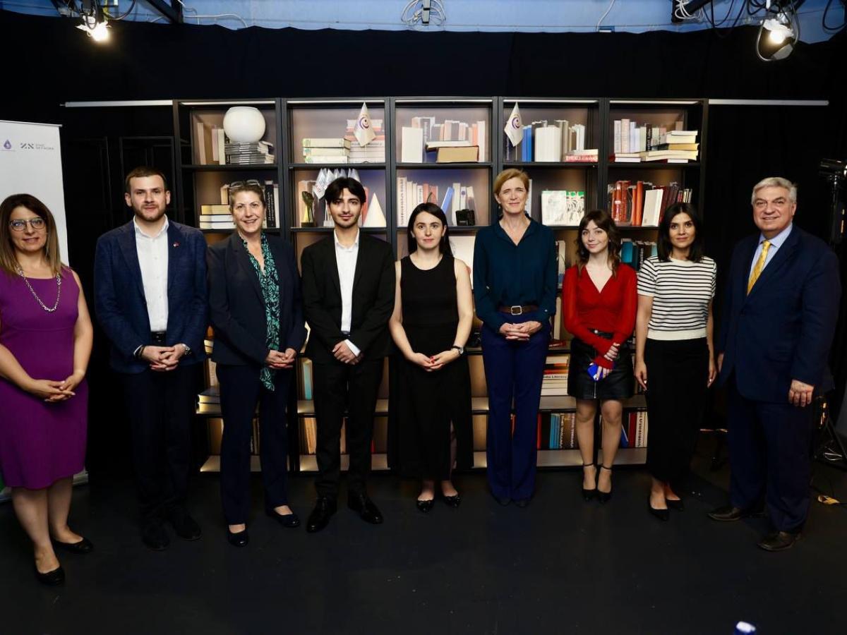 a group of 9 people stand in a row