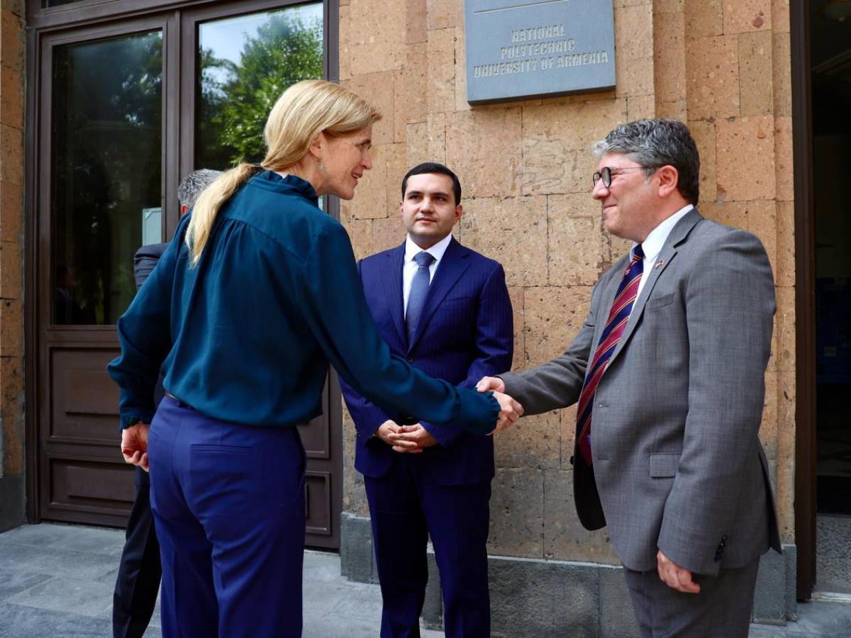 A woman and a man shake hands