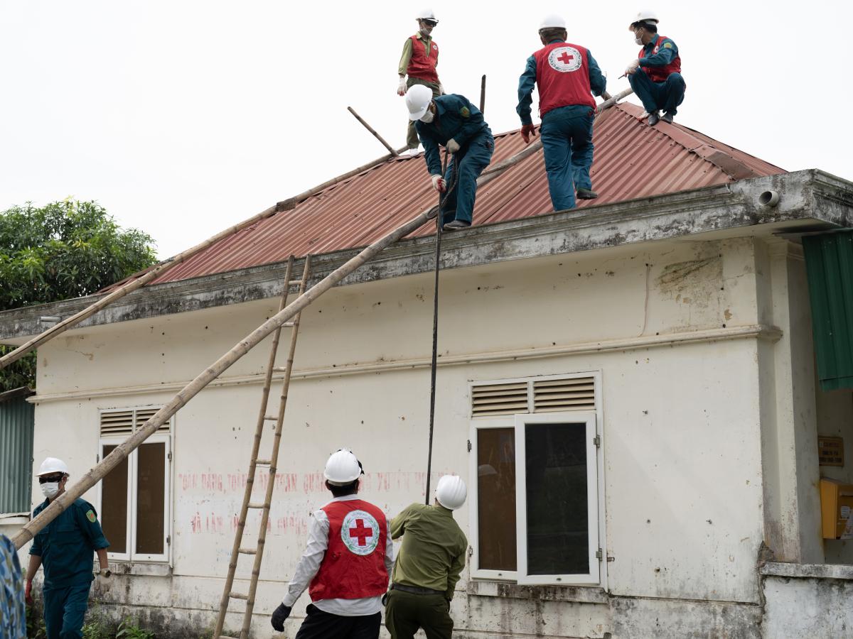 Throughout the morning, community members reinforce homes to withstand hurricane level winds