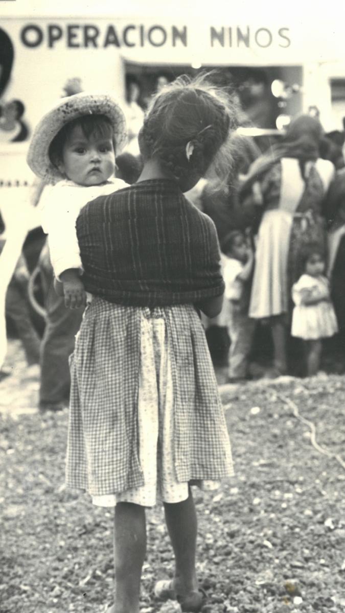 A historical photo of a woman holding a child