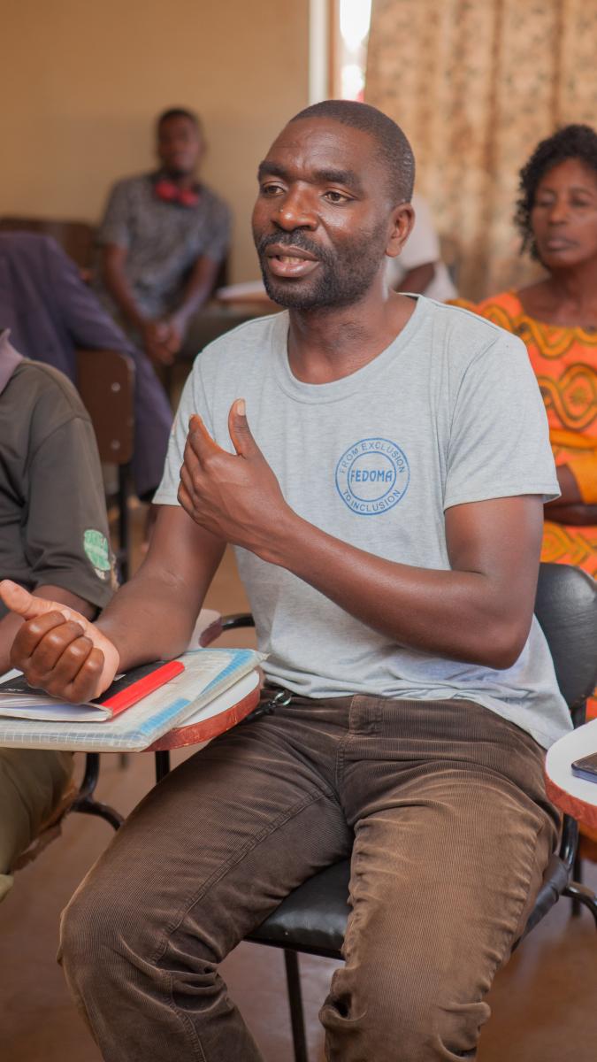 Mponela community members discuss their participation at a “citizen hearing,” supported by USAID, which helped bring to light challenges and needs for the community’s maternity ward.