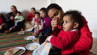 This mother in Assiut governorate attends a healthy nutrition class with her child. USAID helps community health workers provide low cost interventions such as health education through home visits and at primary health clinics.