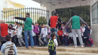 The dad-led School Brigade helps children safely cross the street to school