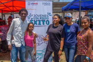 Group of five young Hondurans smiling at the camera.