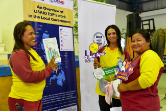 Members of a women's cooperative exchange best practices on how to lowe electricity bills at home