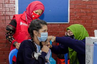 Image of Bangladeshi student receiving Pfizer COVID-19 vaccine