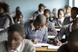 A student works on school work during a governance lesson.