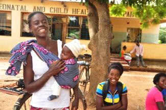 A woman and her baby outside of a maternal and child health clinic in Zambia