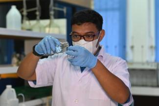 Robby Saputra is testing water quality at Pontianak Water Utility