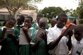 Students outside the classroom write down their work