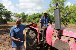 Eji Christopher, CEO of Eji Christopher Tractor Services explains his tractor operations to the Extension Agent during a field visit in Ebonyi State. 