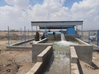 Water flows into a rehabilitated canal for farmers' use.