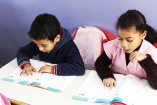 Two Moroccan students reading from their textbooks