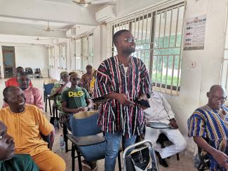 A man participates in a community dialogue session. 