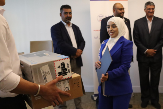 Libyan Audit Bureau staff member receives equipment and training from USAID.