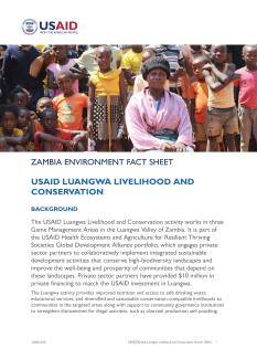 A Zambian woman sits attentively in front of a group of Zambian children in this thumbnail for the Luangwa Livelihood and Conservation fact sheet