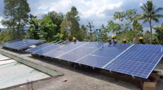 Installers setting up large solar arrays