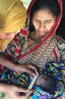 A mother and her baby as the newborn is examined for jaundice with the Icterometer 