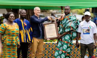 Chief of Azizanya receiving the Most Responsible Fishing Community award on behalf of his community from Andrew Read, Economic Growth Office Director, USAID/GHANA.