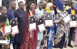 RLC Dakar graduations stand holding certificates