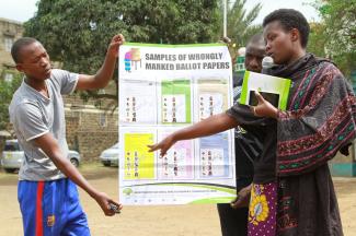 Sarah Alouch, an educator with the Kenya Independent Electoral and Boundaries Commission, provides information to voters.