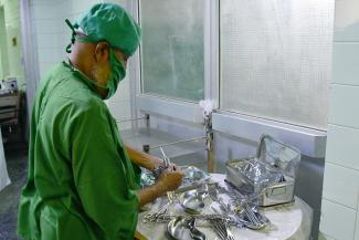 Health worker arranges medical tools provided by USAID. 