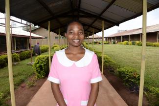 A young woman stands on a covered walkway