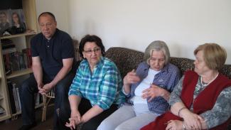 Tenants of Tesanj in Bosnia and Herzegovina converse comfortably inside a warm apartment.