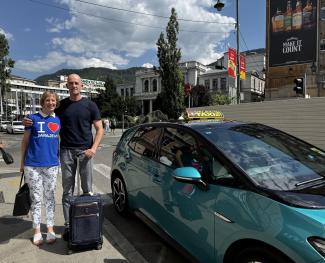 USAID/BiH Mission Director Courtney Chubb and Sarajevo Taxi Association driver Adnan Imamović pose for a photo outside of his taxi.