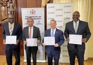 Photo showing Jamaica and USG official at a signing ceremony