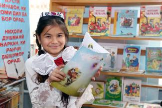 A young student reading a book