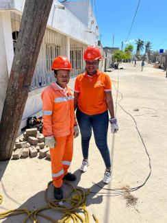 Two women working on electrical utility