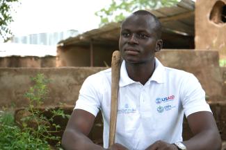 Mamadou Ballo seated in front of the fish pond he used as a composting pit.