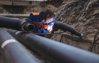 A worker welding pipes. 