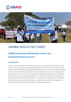 The first page of the fact sheet. The banner image on the first page is of people marching and holding up a banner that reads USAID CHEKUP II.