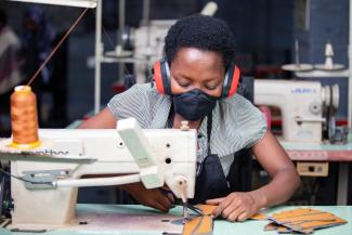 A female worker cuts leather at Uzuri K&Y’s workshop in Kigali, Rwanda. Uzuri K&Y Limited