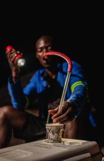 Micheal Banda, a human landing collector, exposes his skin to mosquitoes to trap them as they attempt to bite. 