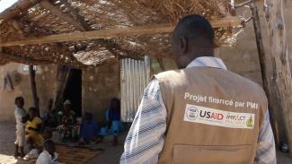 Arrival of CHW Ismeal at Mr. Mahamat's household for educative talk on malaria prevention. Guider, North Cameroon. Captured by Christelle Ngueajio DOC USAID, November 2022.