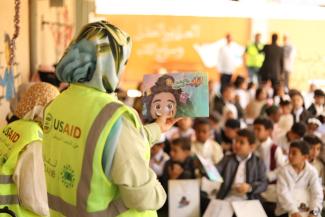 USAID volunteer teaches children about recycling and sustainability in Zliten.