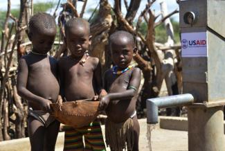 Children in Buluko fill their container with water from a pump built by USAID. Photo credit: AECOM.