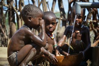 Children in Buluko fill their container with water from a pump built by USAID. Photo credit: AECOM.