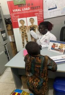 John meets with a health care provider at a USAID-supported health facility. 