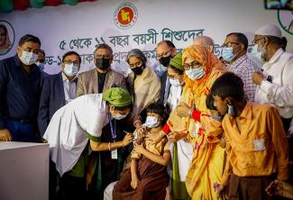 Image of first Bangladeshi child receiving pediatric dose of Pfizer COVID-19 vaccine